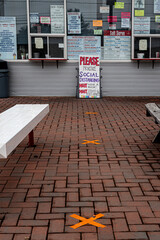 Social Distancing Signs at a local outdoor eatery in Binghamton in Upstate NY in Broome County.  Signs and X on the pavement keep customers safely apart during the COVID Virus.  Ice Cream! 