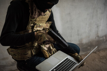 Terrorist man cyber hacker hacking internet to access steal information by laptop computer, robber...