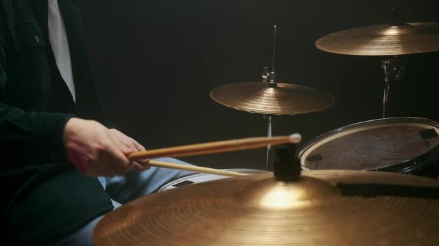 Musician playing drumms during online concert at studio