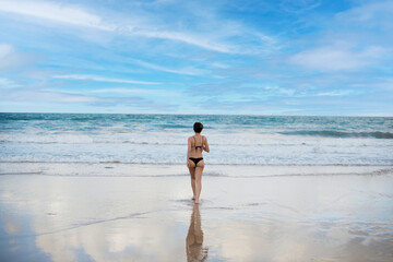Woman going to bathe in the sea.