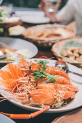 Deep fried shrimp with Tamarind sauce. Popular Thai food. In this dish, there are five shrimps that are topped with the sauce. The vegetables are coriander