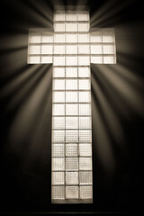 tall window cross of faith light ray shining through.