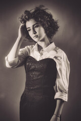 Fototapeta premium Vintage portrait of a young girl with curly hair