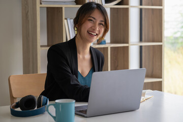Work from home concept, Asian business woman using laptop, communicates on internet with customer...