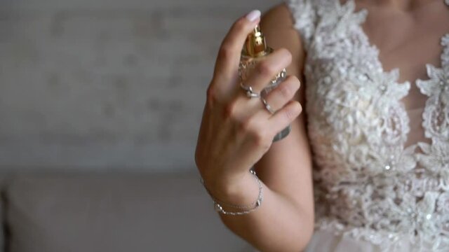 Bride woman using perfume spray. High quality FullHD footage