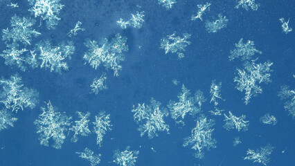 snowflakes on a blue background close up, isolated ice shapes