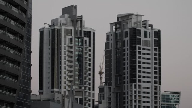 Two Dubai apartment buildings with unique architectural designs in Dubai, United Arab Emirates.
