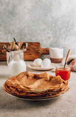 Homemade crepes with sea buckthorn jam and milk.