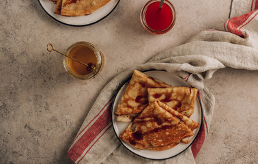Homemade crepes with sea buckthorn jam and milk.