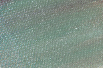creative background of multi-colored primers on linen canvas surface, toning, temporary object
