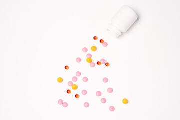 White jar with pills on a light background top view medicine health vitamins