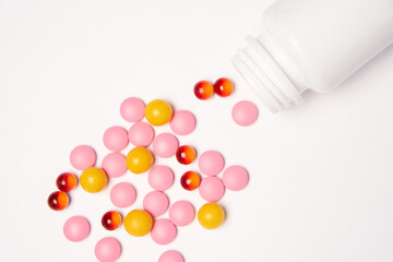 White jar with pills on a light background top view medicine health vitamins