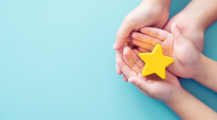 Mother day Concept, Best Excellent mother mom, kid giving a Star Rating to mother.Mother and kid child hand holding star for reward.Family, encourage, School, Student.Child development.Proud, Gifted. - Powered by Adobe