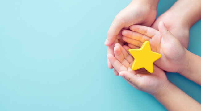 Mother Day Concept, Best Excellent Mother Mom, Kid Giving A Star Rating To Mother.Mother And Kid Child Hand Holding Star For Reward.Family, Encourage, School, Student.Child Development.Proud, Gifted.