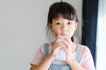 Organic lactose free milk.Asian kid girl drinking milk.Calcium vitamin from milk.Grocery, Good taste.Kid drink.School kid girl, Healthy, yoghurt, mock up product.Delicious tasty.Fruit juice.vitamin C.