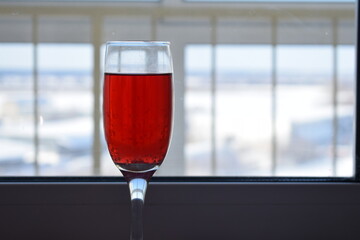 Red wine, red juice in a glass on the table.