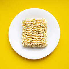 Noodles on a plate. Vermicelli in the shape of a square on a round plate.