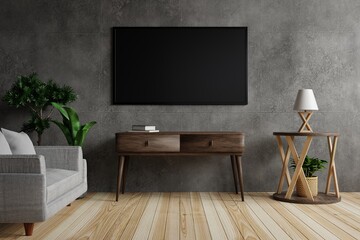 Large TV on a concrete wall in the living room is decorated with lamps, trees and furniture on a beautiful patterned wooden floor.3d rendering.