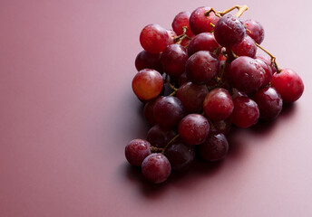Red Globe with water droplets placed on a matte dark red background