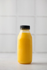 Yellow smoothie in a bottle. The concept of healthy eating. Layout. Copy space.