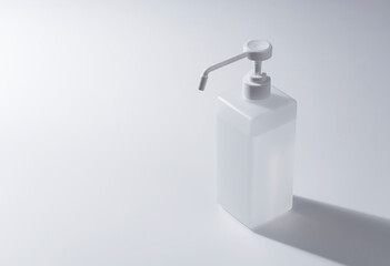 Bottle of alcohol sanitizer spray placed on a white background in a copy space.