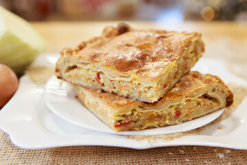 Chicken and potato pie on the dining table. The food is ready to eat. Puff pastry. kitchen utensils for cooking