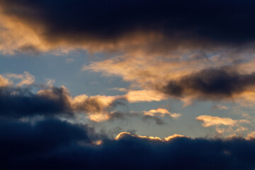 Dark blue clouds. Blue sky, sunset. Beautiful natural background.