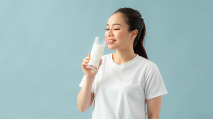 Young woman is drinking milk. Healthy nutrition.