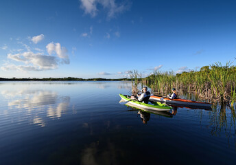 Woman and active senior kayaking on Nine Mile Pond in Everglades National Park.