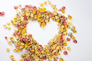 handmade pasta on a white background, love heart symbol, empty space, place for text