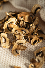 dried chopped mushrooms champignons, scattered on the table in bright daylight, blank, semi-finished product, additive for cooking