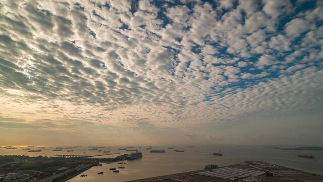 Time-lapse video of Altocumulus cloud and crepuscular rays in the morning off the ocean at Singapore strait.
