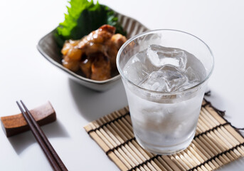 Shochu and nibbles on a white background with a copy space.