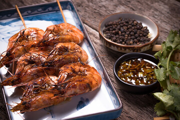 grilled shrimp on skewers. Grilled seafood on skewers with spices, close up