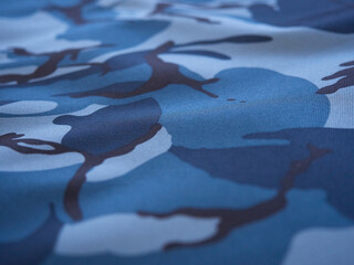 Blue-black camouflage dense fabric, texture, close-up.