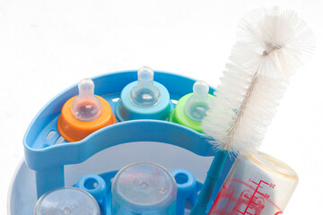 Fototapeta na wymiar baby bottle it was clear that a disinfectant with bottle brush arrangement flat lay style on background white