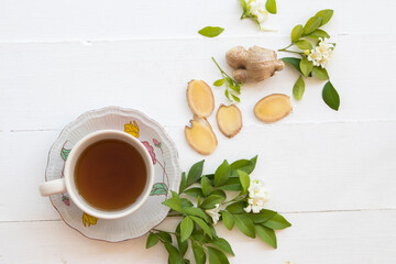 herbal drinks ginger health care sore throat with flowers jasmine arrangement flat lay style on background white wooden