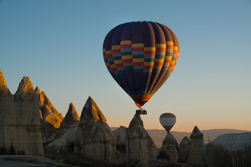 Fototapeta na wymiar Hot air balloon flying over spectacular Cappadocia, Goreme at sunrise.