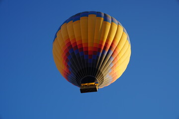 Fototapeta premium Hot air balloon flying over spectacular Cappadocia, Goreme at sunrise.