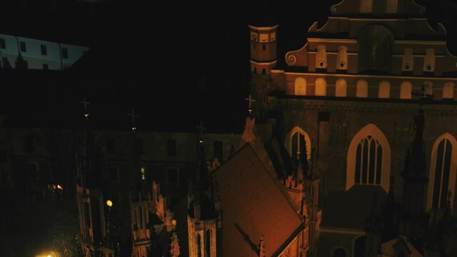 Aerial view of buildings in Old Town Vilnius at night. High angle shot of beautiful ornate building.