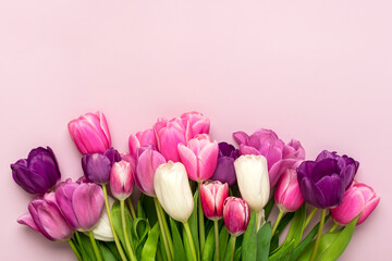 Fototapeta premium Bouquet of tulips isolated on pink background Top view flat lay Happy mother's day, International women's day, Easter concept Holiday card
