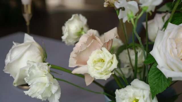Bouquet of rose flowers at the table. Pink and white. High quality FullHD footage