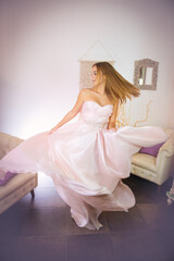 Girl 16 y is dancing in an Atelier, creating effects with the gown 