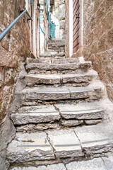 Ancient stone steps leading steeply up an old narrow alleyway in Kotor,Montenegro.