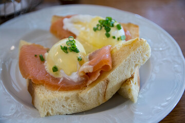 Eggs Benedict Royal, with smoked Salmon, poached eggs, Hollandaise sauce and scallion, over a fresh brioche bread. 