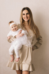 Loving mom carying of her newborn baby at home. Bright portrait of happy mum holding sleeping infant child on hands. Mother hugging her little 4 months old son.