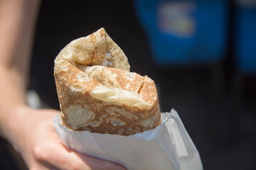 Hand holding a traditional rolled Druze Pita bread, Daliyat al-Karmel, Israel