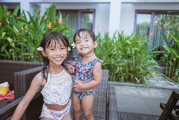 Fototapeta premium portrait of asian two girl in swim wear smiling looking at camera