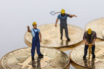three miners standing and working on bitcoin crypto currency