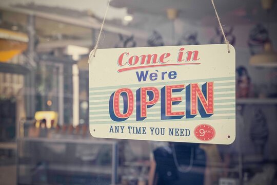 An open sign hanging on the door of a restaurant